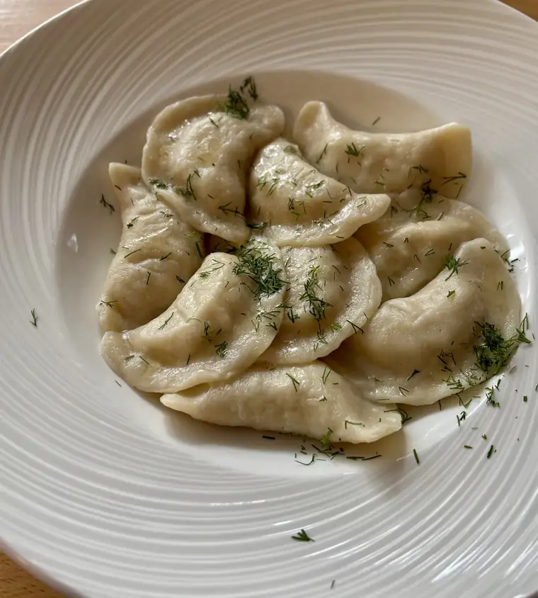 Talerz pierogów posypanych natką